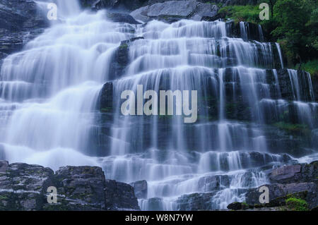 Panoramic image of Tvindefossen waterfall in Norway. Taken with a long exposure to create the blurry water and the sharp rocks. Stock Photo