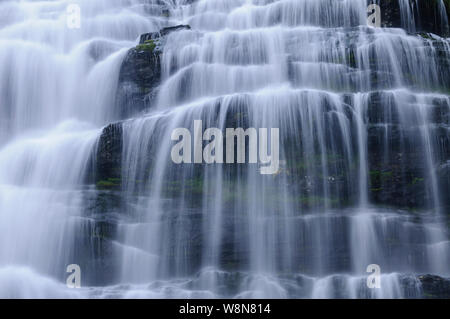 Panoramic image of Tvindefossen waterfall in Norway. Taken with a long exposure to create the blurry water and the sharp rocks. Stock Photo