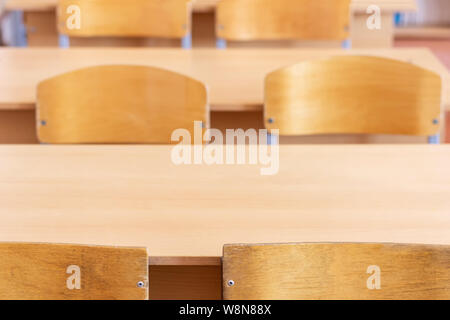 School desks and chairs in a school class, close-up. Beginning of the school year, back to school. Stock Photo