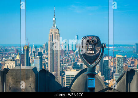 Midtown Manhattan, view from the observation deck of the Rockefeller Center with the Empire State Building visible beyond glass screens, New York City Stock Photo