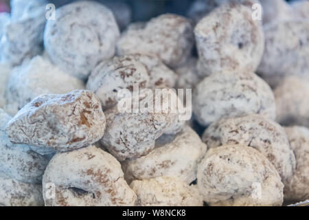 Powdered Sugar Covers Fresh Mini Donuts in pile Stock Photo