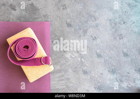 Open yoga mat with cork  block and yoga strap Yoga practice props background. Copy space. Stock Photo