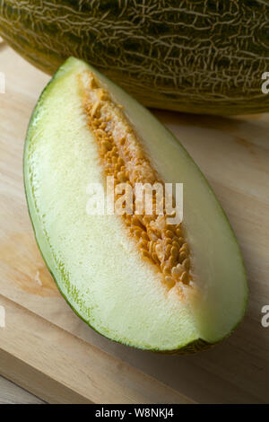 Piece of fresh ripe juicy Piel de sapo melon and seeds Stock Photo