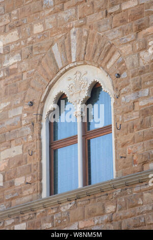 Arch Window with Stone carving on an Italian Building Stock Photo