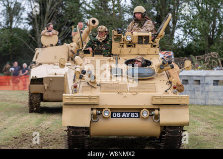 Organised by the Essex Historic Military Vehicle Association, the Echoes of History event is a full weekend of military displays and re-enactments involving hundreds of military vehicles and enthusiasts. Battle re-enactments are carried out during the day. Female tank commander Stock Photo