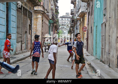 Kids playing soccer on havana street Stock Photo