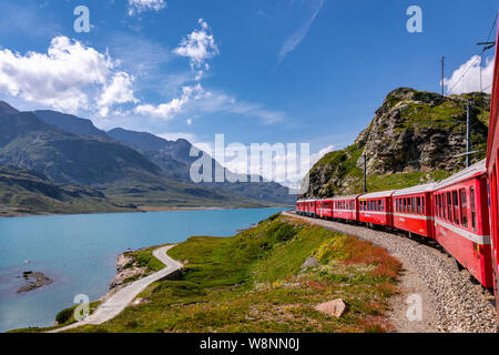 Rhaetian Railway, Bernina Express at Lago Bianco lake, Bernina Pass, Pontresina, Canton of Graubünden, Switzerland Stock Photo