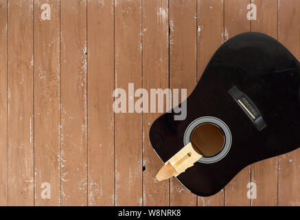 Guitar repair and service - broken sound board acoustic guitar top view wooden background Stock Photo