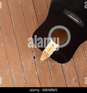 Guitar repair and service - Fragment broken sound board acoustic guitar top view wooden background Stock Photo