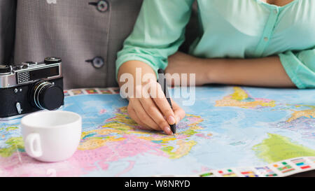 Couple studying world map and marking city to visit Stock Photo