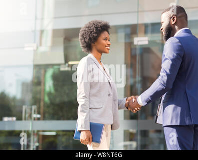 Nice to meet you. Two african business people introducing outdoors Stock Photo