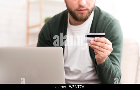 Man purchasing product online, using credit card to pay Stock Photo