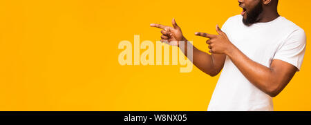 Unrecognizable african guy pointing both hands aside at free space Stock Photo