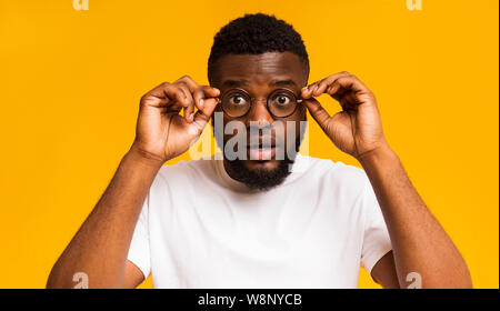 Man showing his big eyes in glasses, posing to camera Stock Photo