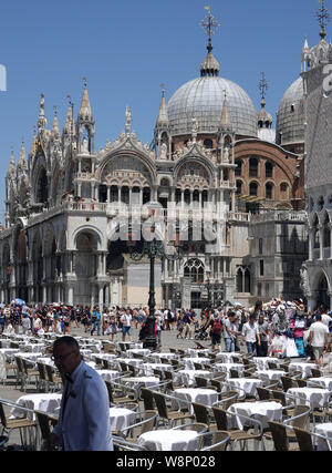 18 June 2019, Italy, Venedig: Empty tables in the restaurants in Piazza San Marco next to Doge's Palace (Palazzo Ducale, r) and St. Mark's Basilica (Basilica the San Marco). Photo: Soeren Stache/dpa-Zentralbild/ZB Stock Photo