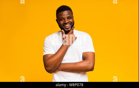 Handsome african american man touching chin, copy space Stock Photo