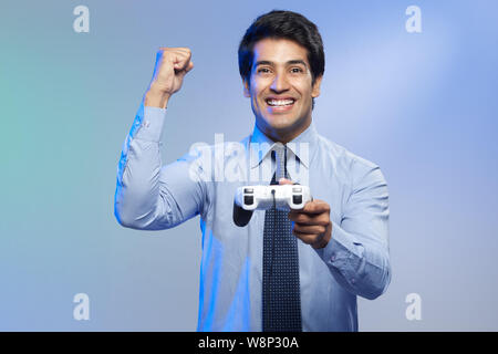 Businessman playing video game Stock Photo