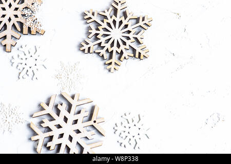 Christmas card concept with snow flakes on vintage wooden background Stock Photo
