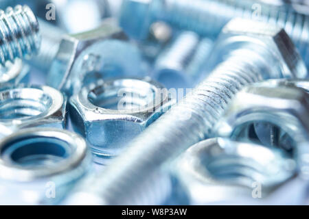 Metal bolts and nuts  in a row background. Chromed screw bolts and nuts isolated. Steel bolts and nuts pattern. Set of Nuts and bolts. Tools for work. Stock Photo