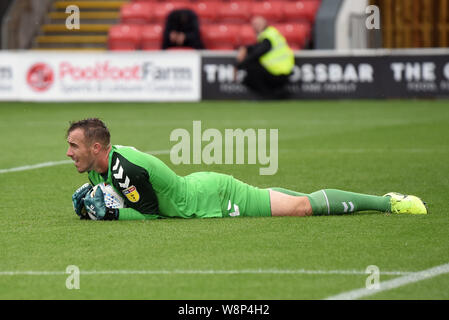 Highbury Stadium, Fleetwood Town, Lancashire, UK. 10th August, 2019. English Football League One, Fleetwood Town versus Wimbledon; Goalkeeper Alex Cairns of Fleetwood Town runs down the clock at the end of the game by lying on the ball - Strictly Editorial Use Only. No use with unauthorized audio, video, data, fixture lists, club/league logos or 'live' services. Online in-match use limited to 120 images, no video emulation. No use in betting, games or single club/league/player publications Credit: Action Plus Sports Images/Alamy Live News Stock Photo