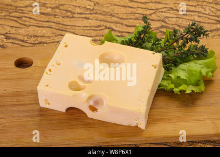 Maasdam cheese brick with thyme branch Stock Photo