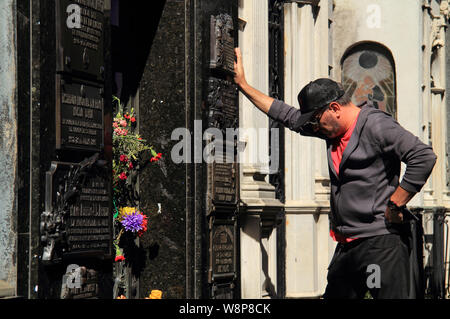 A man pays his respects at the mausoleum of Eva Peron, located in the historic Recoleta Cemetery in the city of Buenos Aires, Argentina Stock Photo