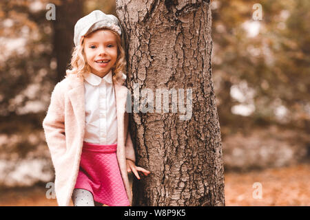 Stylish kid girl 5-6 year old wear trendy casual sweater and jeans pants  walking in park outdoors. Springtime. Little child over nature spring  backgro Stock Photo - Alamy
