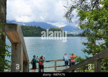 SLOVENIA, BLED - JULY 15, 2019: Beautiful mountain lake in summer with small Church on an island with european alps in the background. Stock Photo