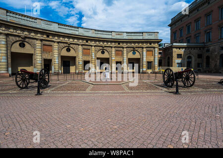 Stockholm, Sweden -- July 18, 2019. A wide angle photo of a guard on duty outside the Royal Palace in Stockholm. Stock Photo