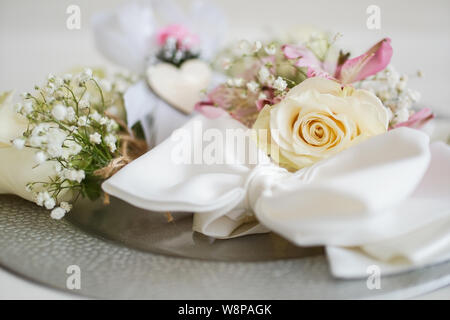Straw basket with yellow rose, wedding accessories and other gifts on the table. Wedding concept Stock Photo