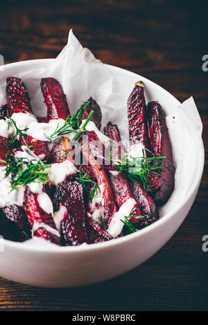 Oven baked beet fries with sour cream and dill dressing Stock Photo