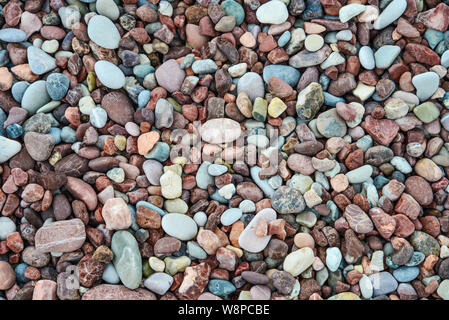 Colorful wet sea stones on beach, top view. May used as background. Stock Photo