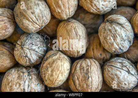 Natural walnut background pattern texture Abstract walnuts heap pattern background Blurred edges frame Natural food in-shell nuts walnuts pattern Stock Photo
