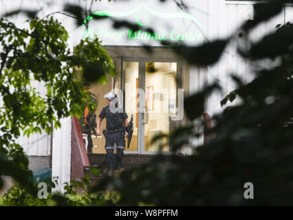 Oslo, Norway. 10th august, 2019. (190810) -- OSLO, Aug. 10, 2019 (Xinhua) -- A police officer walks out of the Al-Noor Islamic Center after a shooting in Baerum, near Oslo, Norway, on Aug. 10, 2019. A dead person was found after the Mosque shooting outside Oslo on Saturday, and it was being investigated in related to the shooting incident, police said late Saturday. (NTB Scanpix/Handout via Xinhua) Credit: Xinhua/Alamy Live News Stock Photo