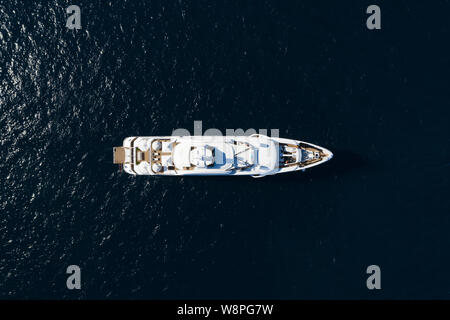 View from above, stunning aerial view of a luxury yacht sailing on a blue sea. Emerald Coast (Costa Smeralda) Sardinia, Italy. Stock Photo