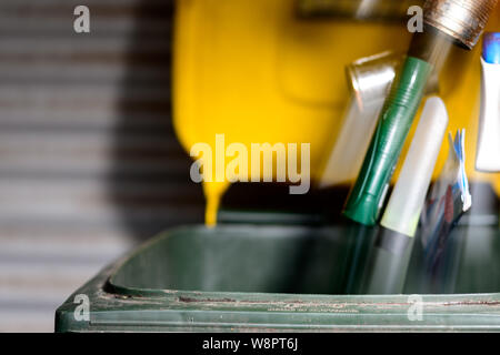 Filling the household Recycling Bin with plastic containers and empty tin cans Stock Photo