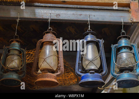 Rusted kerosene lamps hanging from a ceiling used as interior decorations Stock Photo