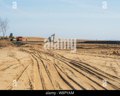 heavy duty machinery working on highway construction site. Bulldozer, dumper truck, soil compactor and vibratory roller Stock Photo