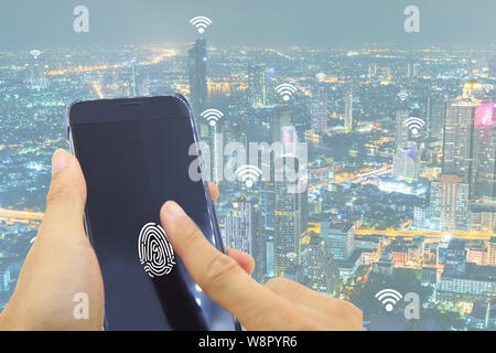 finger print on smartphone for access wifi network / finger print on smartphone with Cityscape of Bangkok with added generic wifi signals background Stock Photo