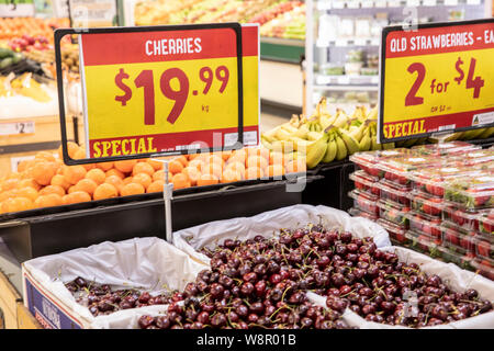 Fresh cherries and queensland strawberries on sale at a Harris Farm supermarket store in Sydney,Australia Stock Photo