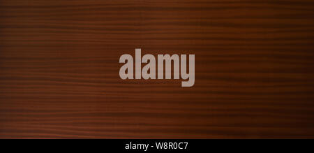 Natural brown wood panel with distinctive woodgrain in a full frame panoramic background texture and pattern Stock Photo