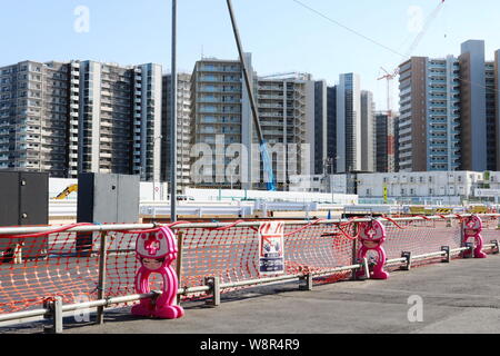 Road barrier by building work in Harumi. In the background are under-construction apartment blocks that are part of 2020 Olympic Village. 9/2019 Stock Photo