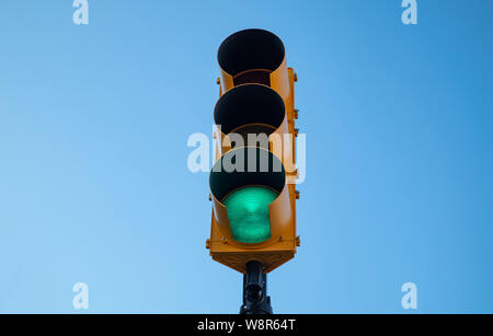 Go sign. Green traffic light for cars, blue sky background Stock Photo