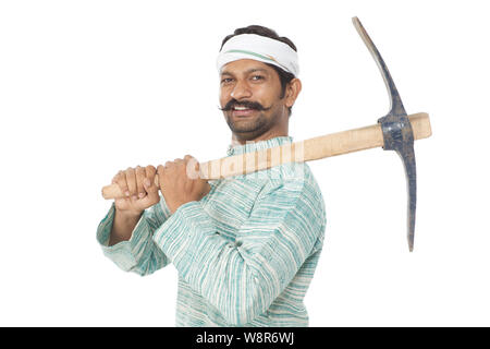 Farmer carrying a pick axe on shoulder isolated on white background Stock Photo