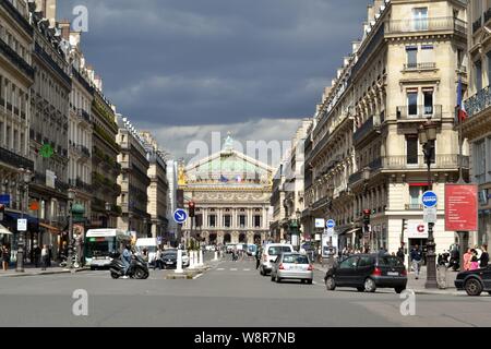 Paris/France - August 19, 2014: View to the Opera de Paris at the end of the Avenue de l'Opera illuminated by the sun before the storm.