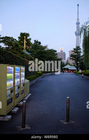 Tokyo / Japan - 31st July 2019: Asakusa district. Vending machines on the streets with the Tokyo Skytree in the background. Stock Photo