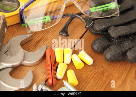 Gloves with tool on a workbench Stock Photo