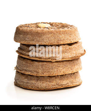 Stack  of wholemeal crumpets isolated on white background Stock Photo