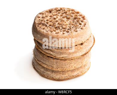 Stack  of wholemeal crumpets isolated on white background Stock Photo