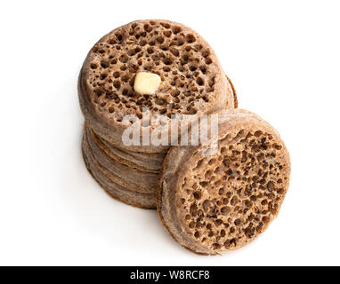 Stack  of wholemeal crumpets isolated on white background Stock Photo